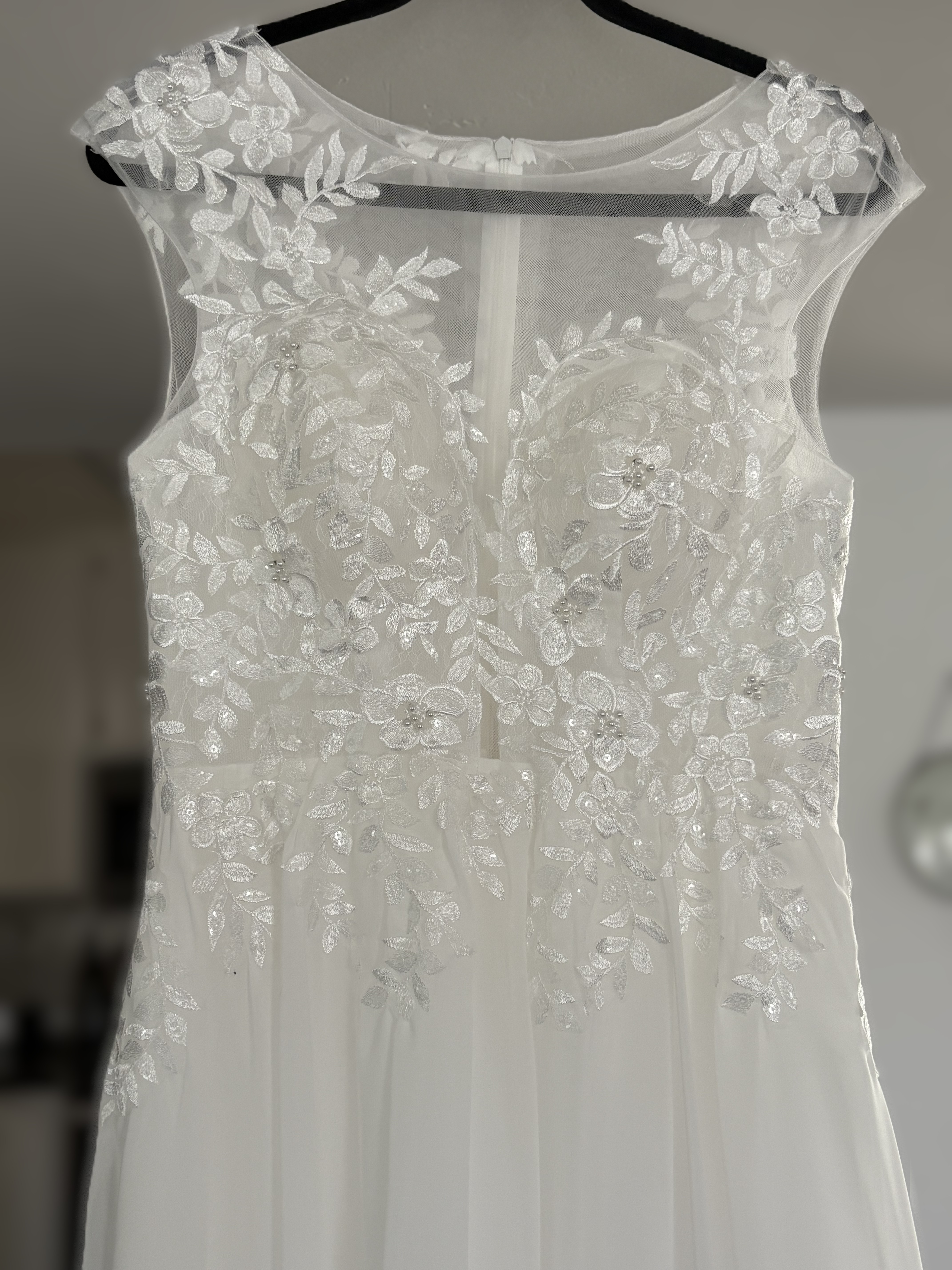 Close-up of floral lace and illusion bodice on a wedding dress