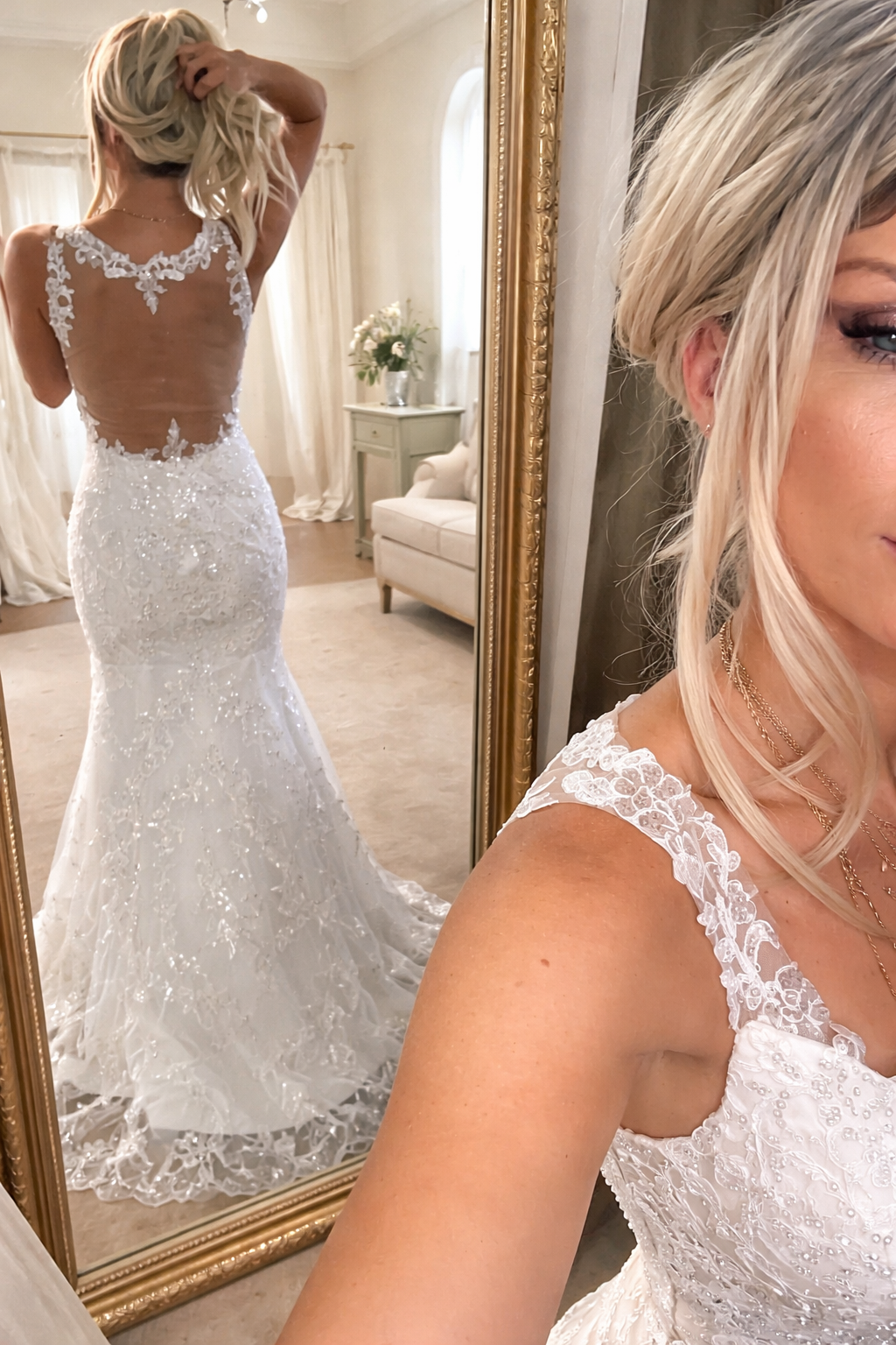 Back view of a lace wedding dress in a bridal suite mirror